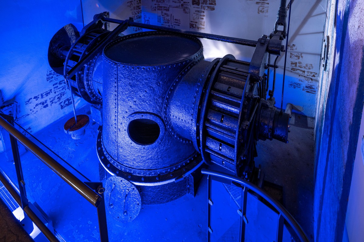 Turbine in the blue light in the historic hydroelectric power station of the former factory
