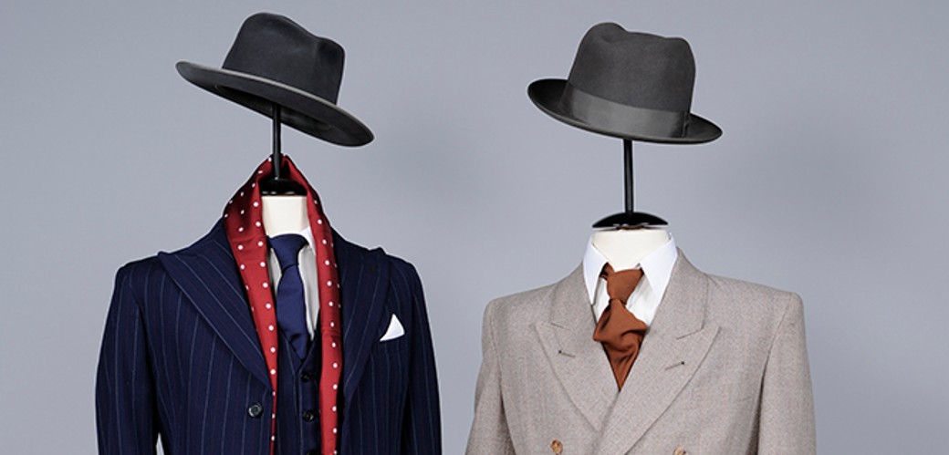 Zwei Herrenanzüge aus Wolle und Kunstseide mit Krawatten und Hüten