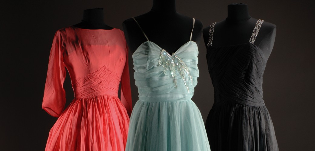 Three elegant evening dresses on figurines