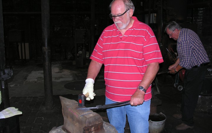 Man forges something on an anvil
