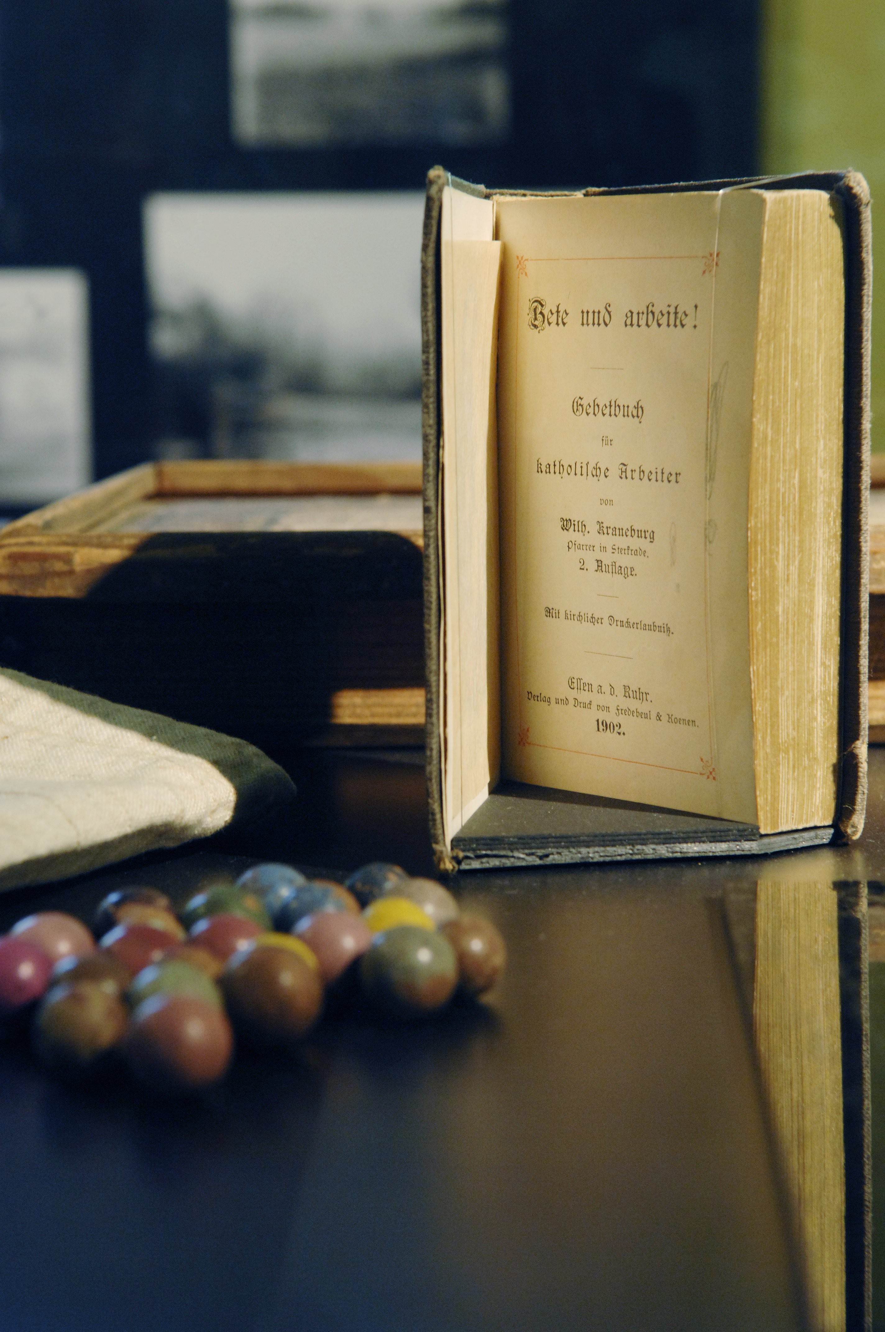 Clay marbles were one of the few toys available to workers’ children and prayer books often the only literature.