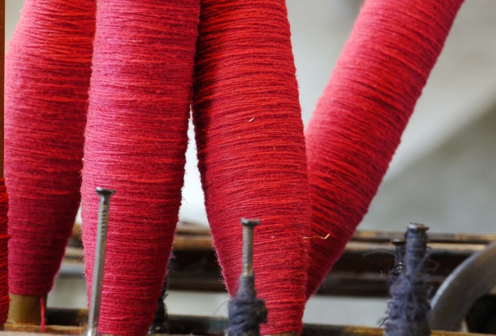 Detail view of four red thread spindles
