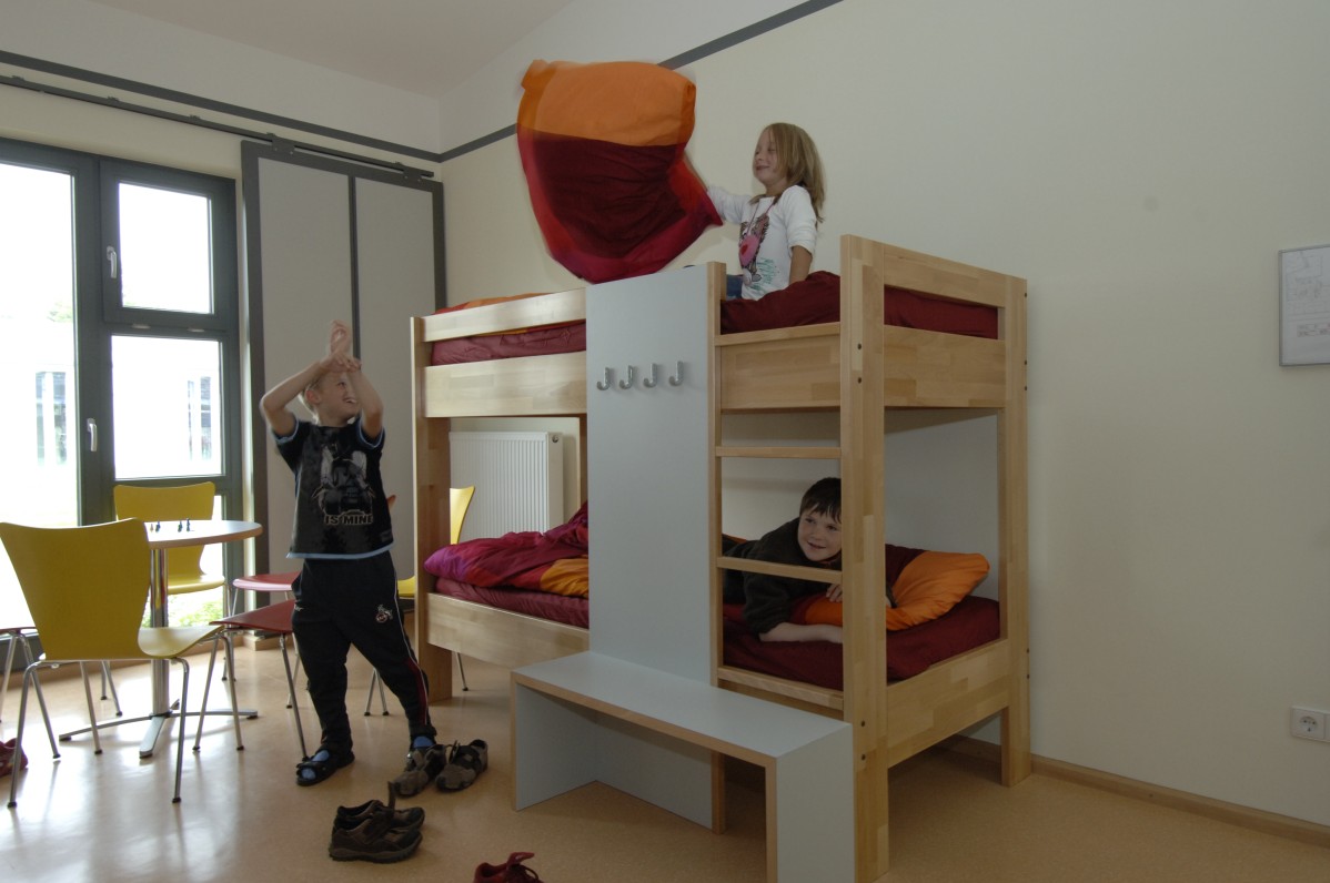 Glance into a bedroom where children are having a pillow fight
