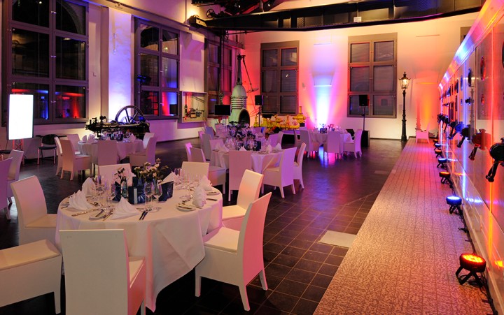 Interior shot of the electrical center of the Altenberg zinc factory covered with white tables at a company event