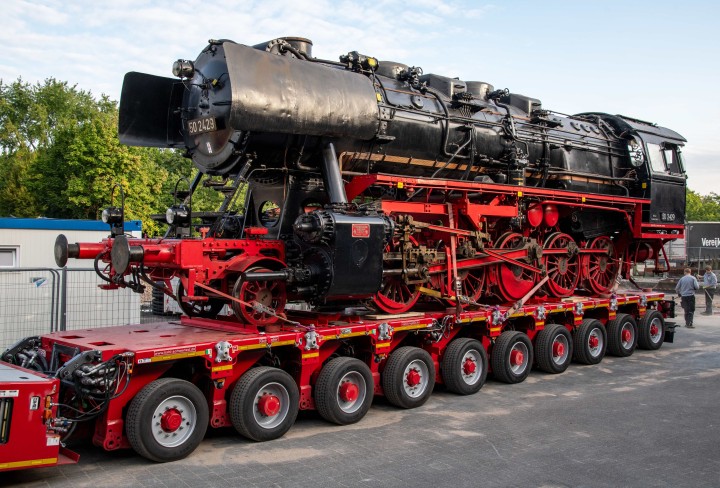 Eine Dampflokomotive auf einem Anhänger.