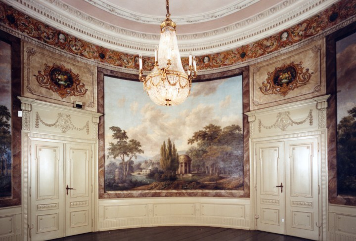 Glance into the magnificent garden room, with wall paintings, stucco and chandelier