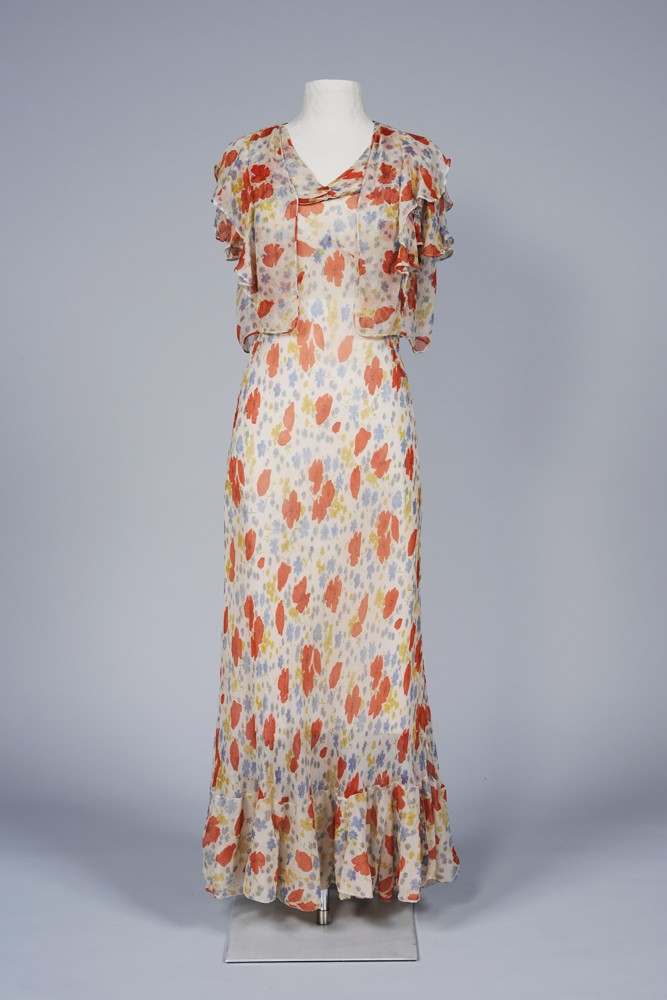 Langes Kleid mit passender Kurzarm-Jacke, beides aus Seidenchiffon mit Blumenmuster, an einer Figurine